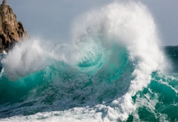 a large wave against a rock