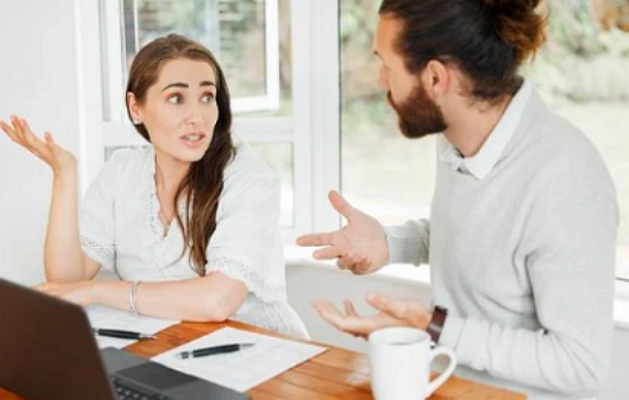 Woman and man having a disagreement at work, Conflict Resolution and wanting stress-free harmony